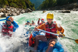 Rafters get splashed as they go through some big rapids on the Karnali river in Nepal